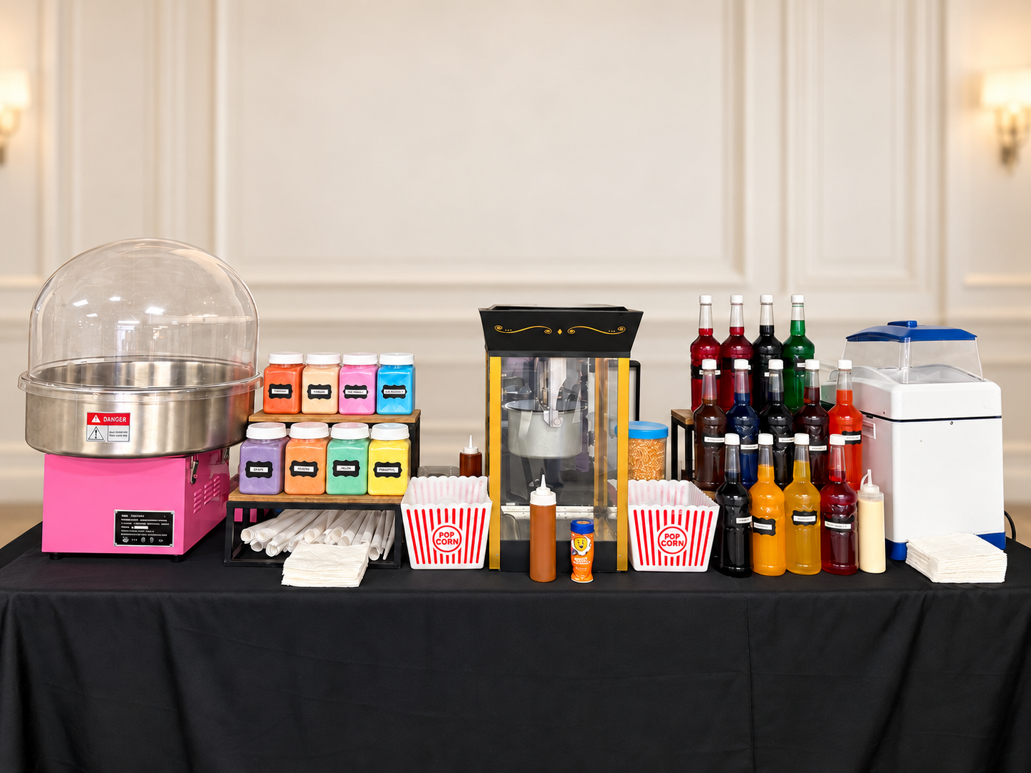 Montaje interior real de Party Fun OKC con máquinas de algodón de azúcar, palomitas y raspas sobre una mesa